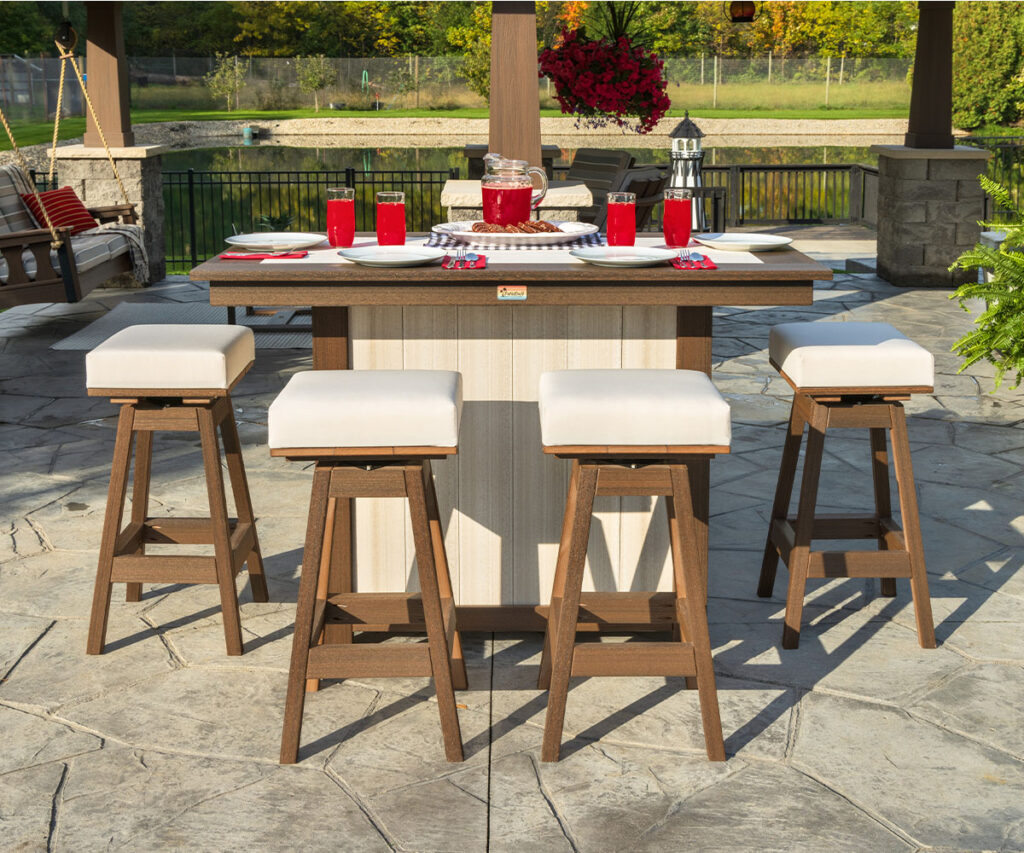 Outdoor poly bar set with cushioned stools on a stone patio beside the pool.