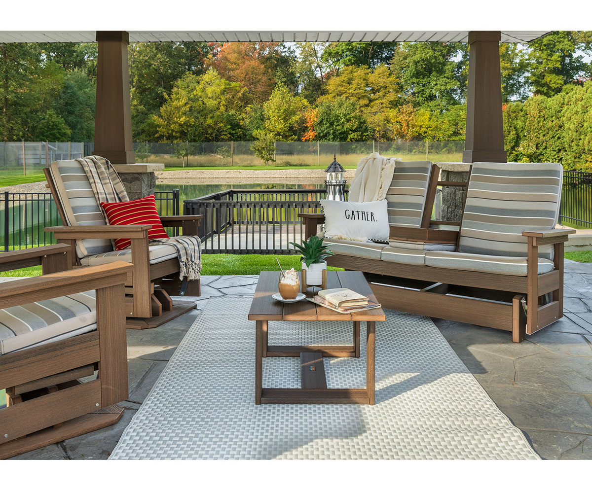 Cozy poly patio seating with striped cushions, throw pillows, and a coffee table vignette.
